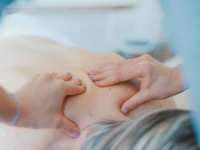 Gentle side-lying treatment applied to a client's shoulder and upper back with bolstering